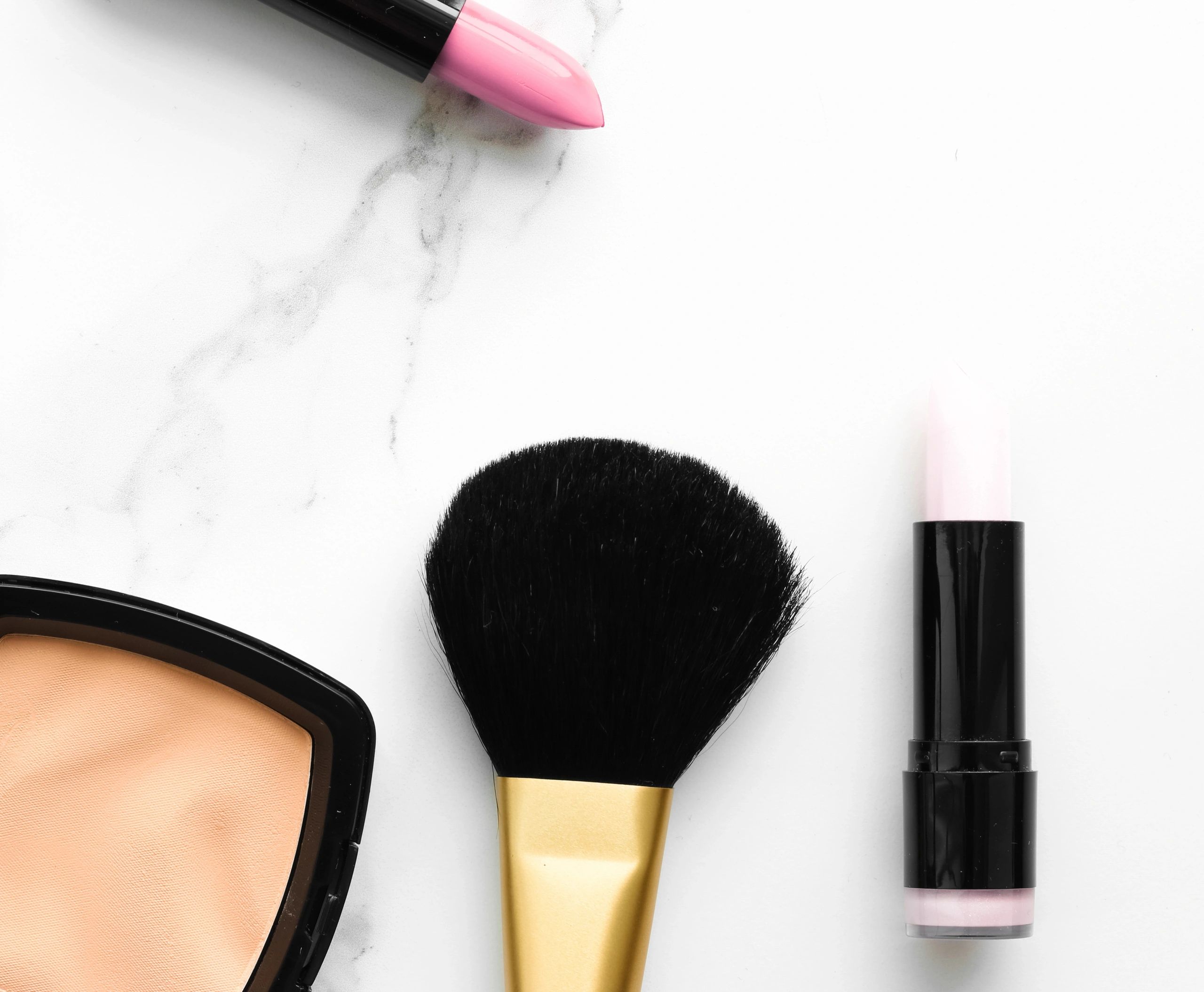 Clean beauty flat lay with cosmetics arranged on a light surface